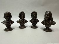 Front view of all four bronze composer busts