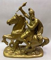 Full side view of gilt metal warrior on horse figurine