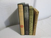 Four Folio Society books in slipcases standing side by side