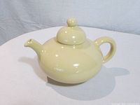 Side view of cream Flowerdale teapot with lid on