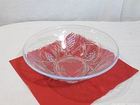 Top view of clear glass bowl showing pinecone relief pattern and iridescent rim