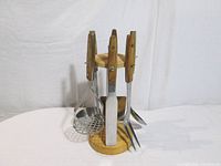 Front view of rack showing four utensils attached