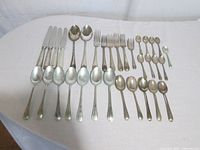 Entire 33-piece Birks Saxon sterling flatware laid out