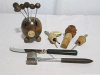 All items in lot including pig holder, picks, pour spouts, stopper, cheese knife, cocktail fork