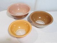 Three Pyrex bowls side by side showing individual colours and interiors