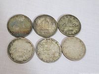 six Canadian silver dollar coins reverse side