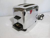 Front angled view showing chrome body, lever and crumb tray