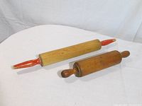 Both rolling pins side by side on table