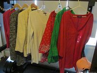 Group of hanging garments showing colors and styles plus sports bra