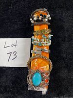 All six bracelets stacked on orange roll showing front details