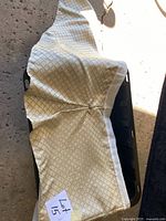 Folded queen bed skirt showing cream base and beige lattice pattern with pleat detail