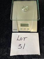 Front view of Starfrit digital food scale showing glass platform and controls