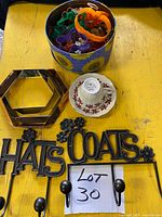 Group shot showing cookie cutters in tin, hexagonal mirror, Colclough teacup & saucer, Hats & Coats rack