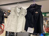 Front view of both vests showing colors, sizes, and front details