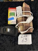 Lot overview showing heating pad, pill organizer box, two black masks