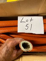 Close-up of sleeve end showing white fiberglass lining and orange silicone exterior