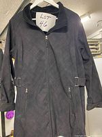 Front view of black softshell jacket on hanger