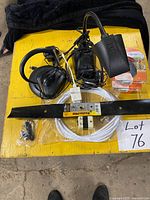 All items laid out: Poulan Pro blade, TV antenna components, Off Clip-On pack, headset, cables and adapter