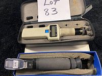 ATAGO refractometer in blue foam-lined box and Veeder-Root tachometer in zippered case with accessories