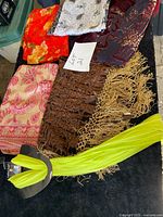 All six scarves and shawls laid out together