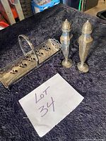 Cracker server and pair of salt and pepper shakers on dark cloth