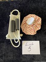 Ice bag and sock aid displayed side by side on dark surface