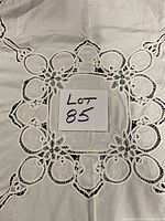 Close view of central cutwork design and lace detailing with lot number