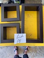 Top view of three dark brown wood box frames on table