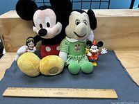 All four Disney items with ruler for scale