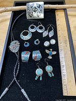 Overall lot with all jewellery items displayed beside ruler