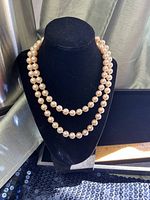 Double-strand pearl bead necklace on black display bust
