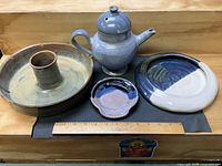 All four pottery pieces with ruler for scale