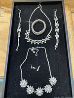 Overview of all rhinestone jewellery pieces in black tray