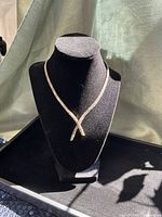 Full view of sterling silver crossover necklace on display bust