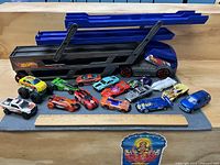 Overall view of car carrier with all cars displayed on grey mat