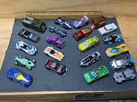 All 18 vehicles laid out on cloth with ruler
