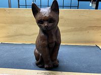 Front view of wooden cat figurine