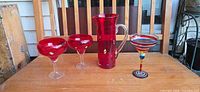 Group shot of red art glass pitcher and three margarita glasses
