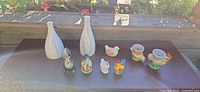 Group shot showing all items: two vases, four shakers, two egg cups, chicken figurine