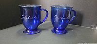 Pair of cobalt blue Starbucks stemmed mugs front view