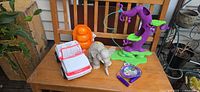 Group shot of all five toys on wooden bench