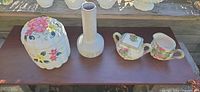 Cookie jar, vase, sugar bowl and creamer grouped on shelf