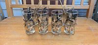 Front view of seven pheasant glasses in eight-slot metal carrier
