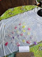 Overhead view showing all 23 wine glasses arranged on table with colored accents visible