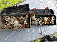 Two plastic toolboxes open showing all capacitors