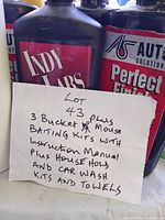 Handwritten lot note in front of Auto Solutions bottles