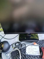 Front view of Acer monitor with speaker, keyboard, mouse and cables visible