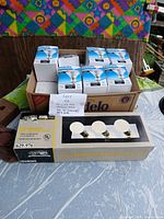 Philips bulb cartons and Hampton Bay bath bar box displayed together