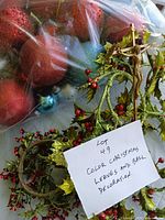 Bagged glitter Christmas balls, holly garland, crucifix