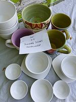 Group shot of all dishes, bowls, and mugs on table surface